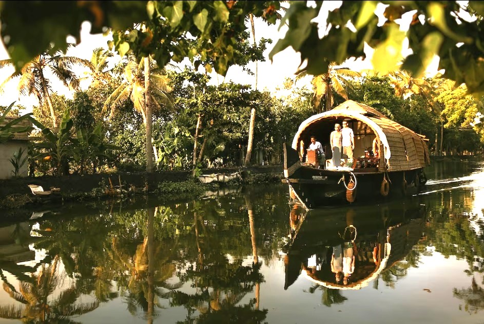Luxury Kerala houseboat cruise in Alleppey backwaters with palm-lined canals and private deluxe interiors South India tour
